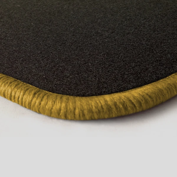 Eine Ecke als Beispiel einer Fussmatte Nadelfilz schwarz mit Rand in gold.