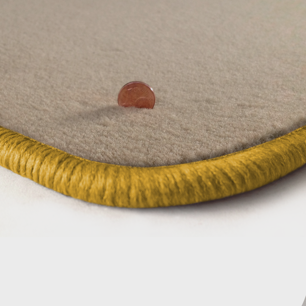 Eine Ecke als Beispiel einer Fussmatte Velours beige mit Rand in gelb.