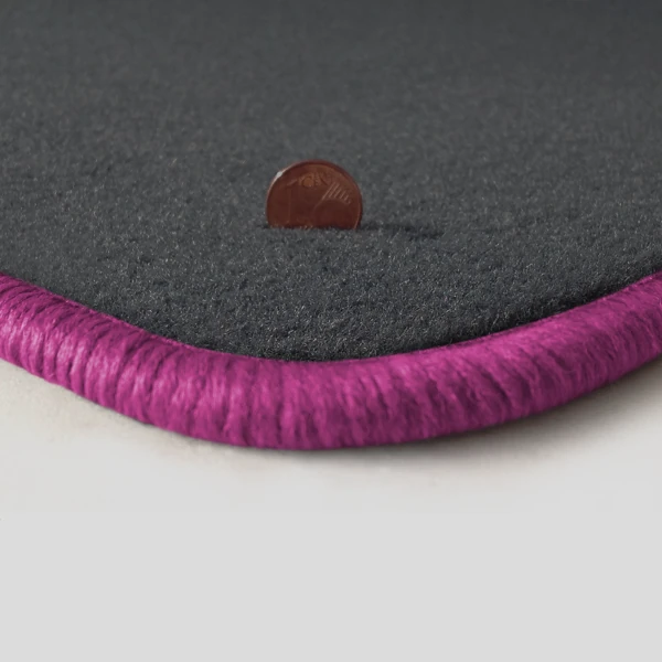 Eine Ecke als Beispiel einer Fussmatte Velours dunkelgrau mit Rand in pink.