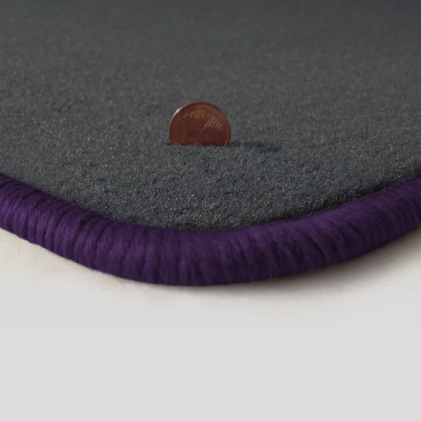 Eine Ecke als Beispiel einer Fussmatte Velours dunkelgrau mit Rand in violett.
